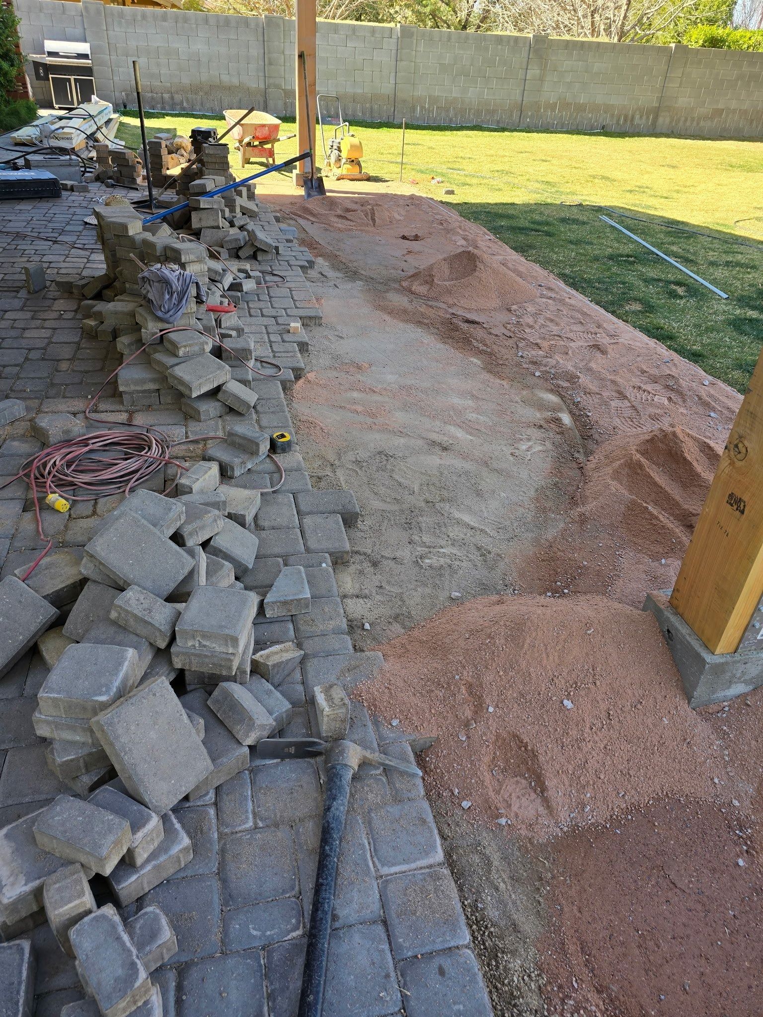 A pile of bricks is sitting on top of a pile of dirt.