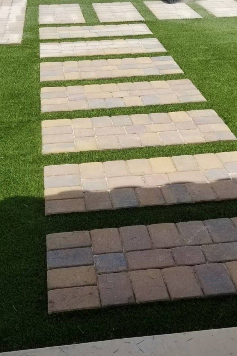 A walkway made of bricks and grass.