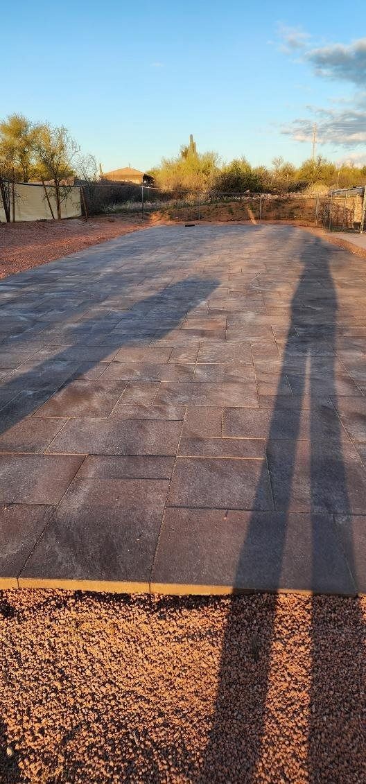 A shadow of a person is cast on a concrete surface.