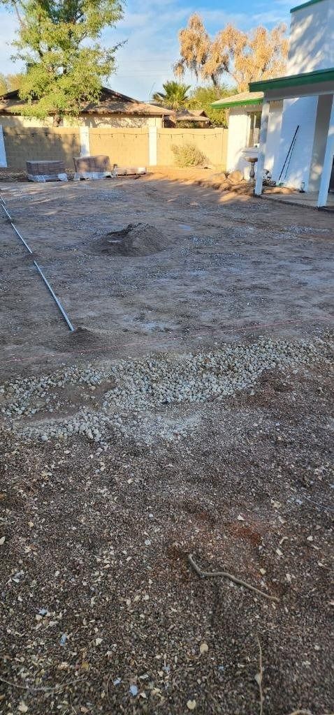 There is a lot of dirt in the backyard of a house.