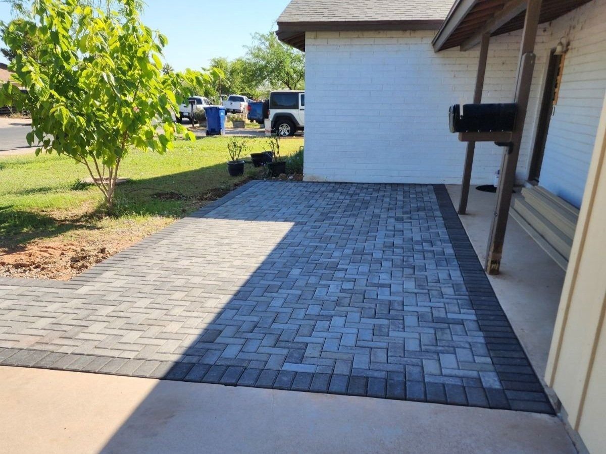 A driveway with bricks in front of a house
