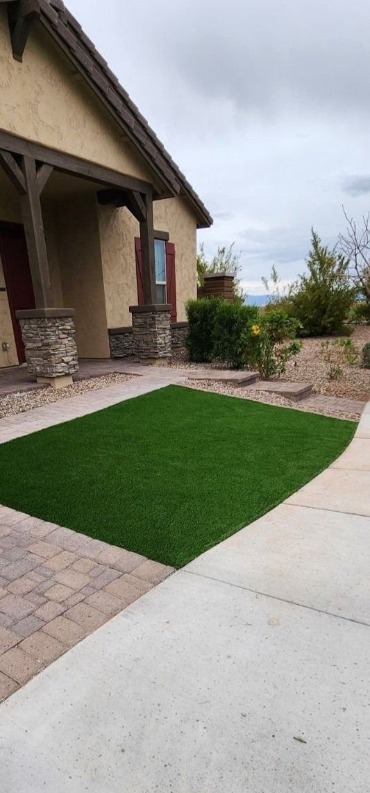A house with a large lawn in front of it.