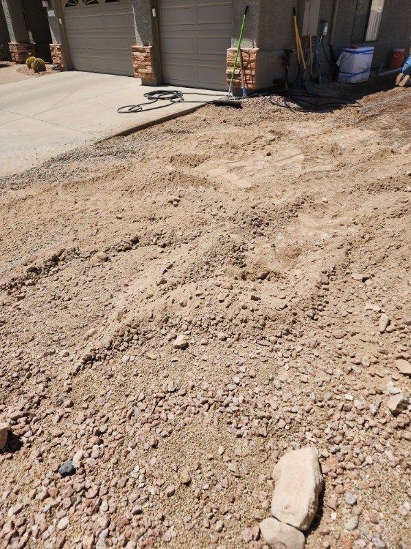 A pile of dirt and rocks in front of a house.