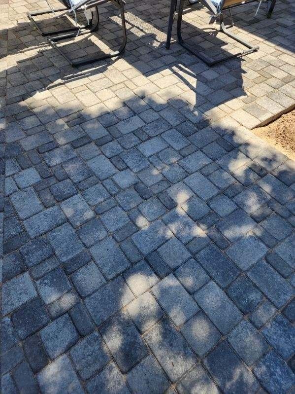 A patio with a table and chairs on it.