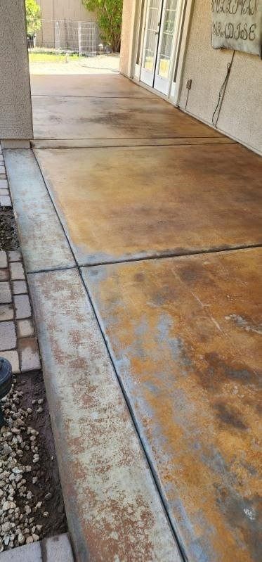 A concrete walkway with a rusty stain on it.