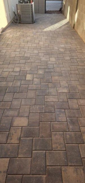 A close up of a brick floor in a room.