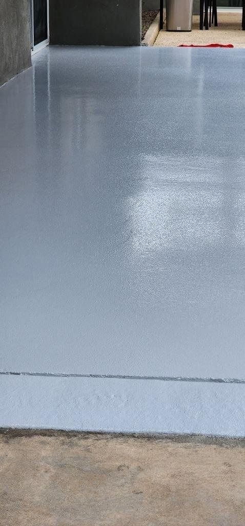 A close up of a gray concrete floor in a garage.