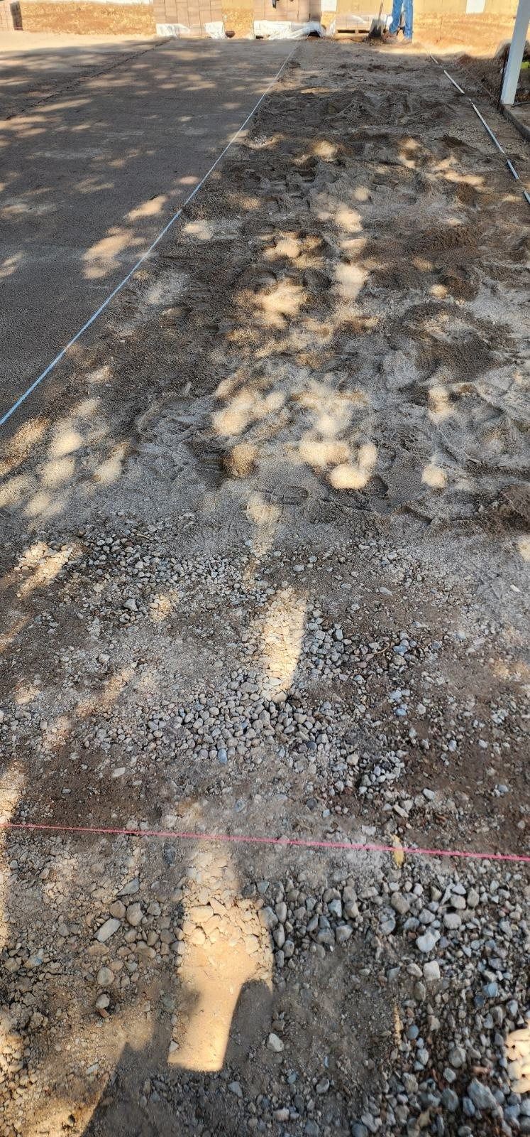 A close up of a dirt road with a red line on it.