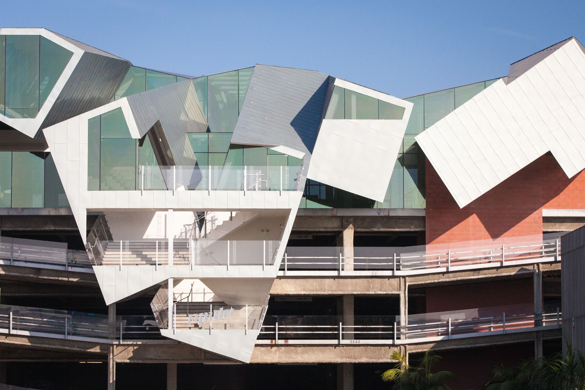 Modern building with geometric, angular facade and protruding balconies.