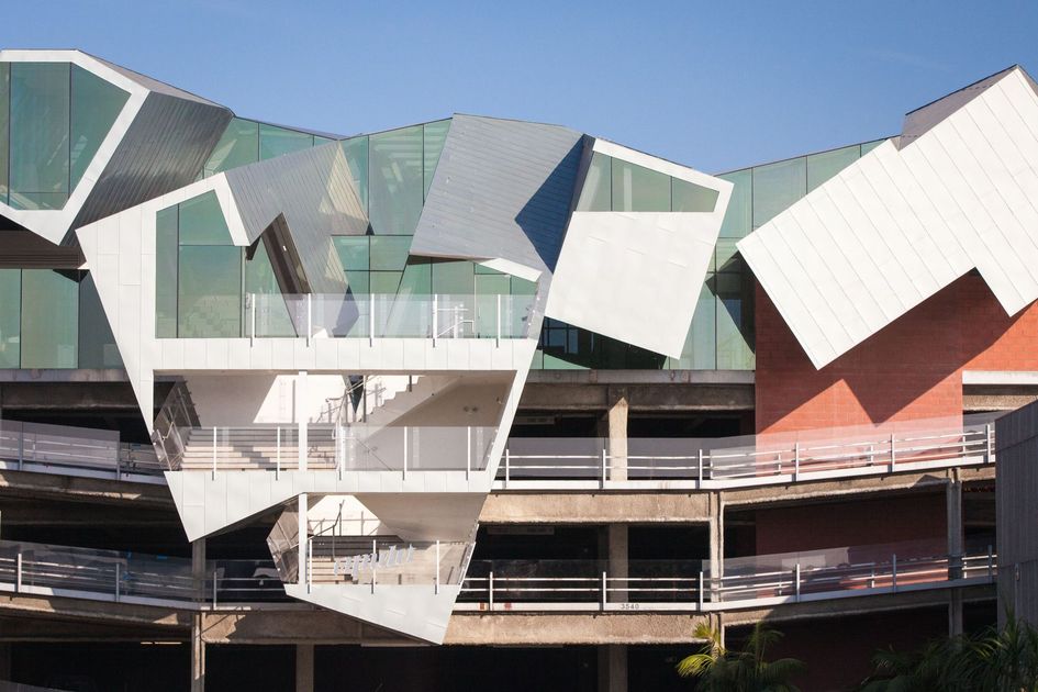 Modern building with geometric, angular facade and protruding balconies.