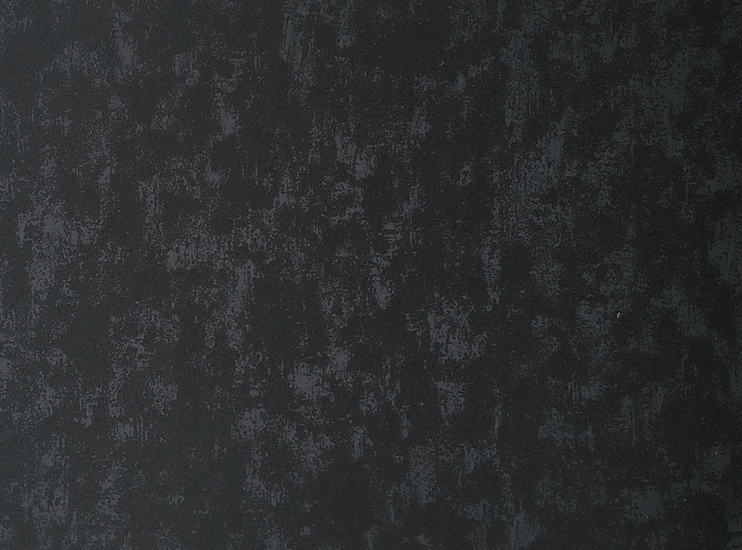 Dark textured background with mottled, uneven patterns.