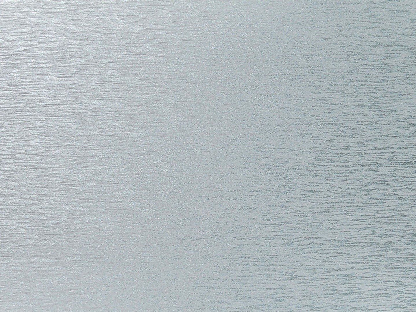 Textured, light blue surface with horizontal striations.