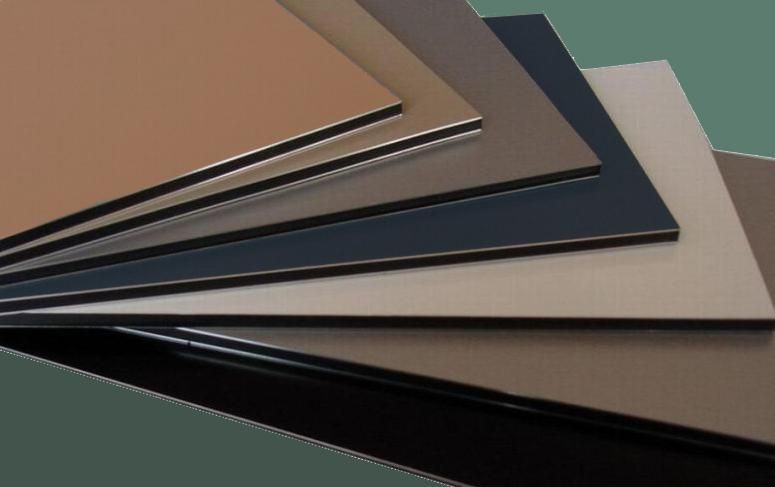 Close-up of a brown, wood-grain desk mat with a rounded corner on a gray surface, office setting.