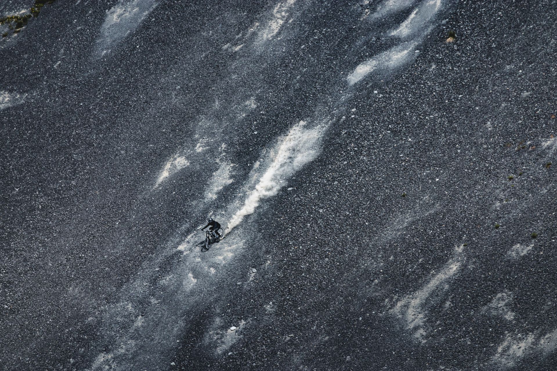 Dark speckled surface with white streaks.