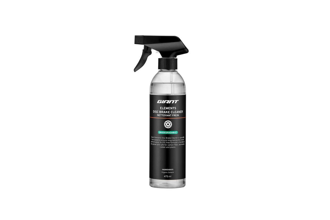 Black and clear spray bottle, black label, green accent, white background.