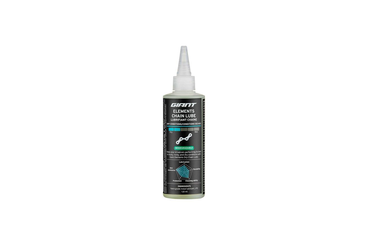 Bottle of bicycle sealant with white nozzle, black label with text, turquoise accents.