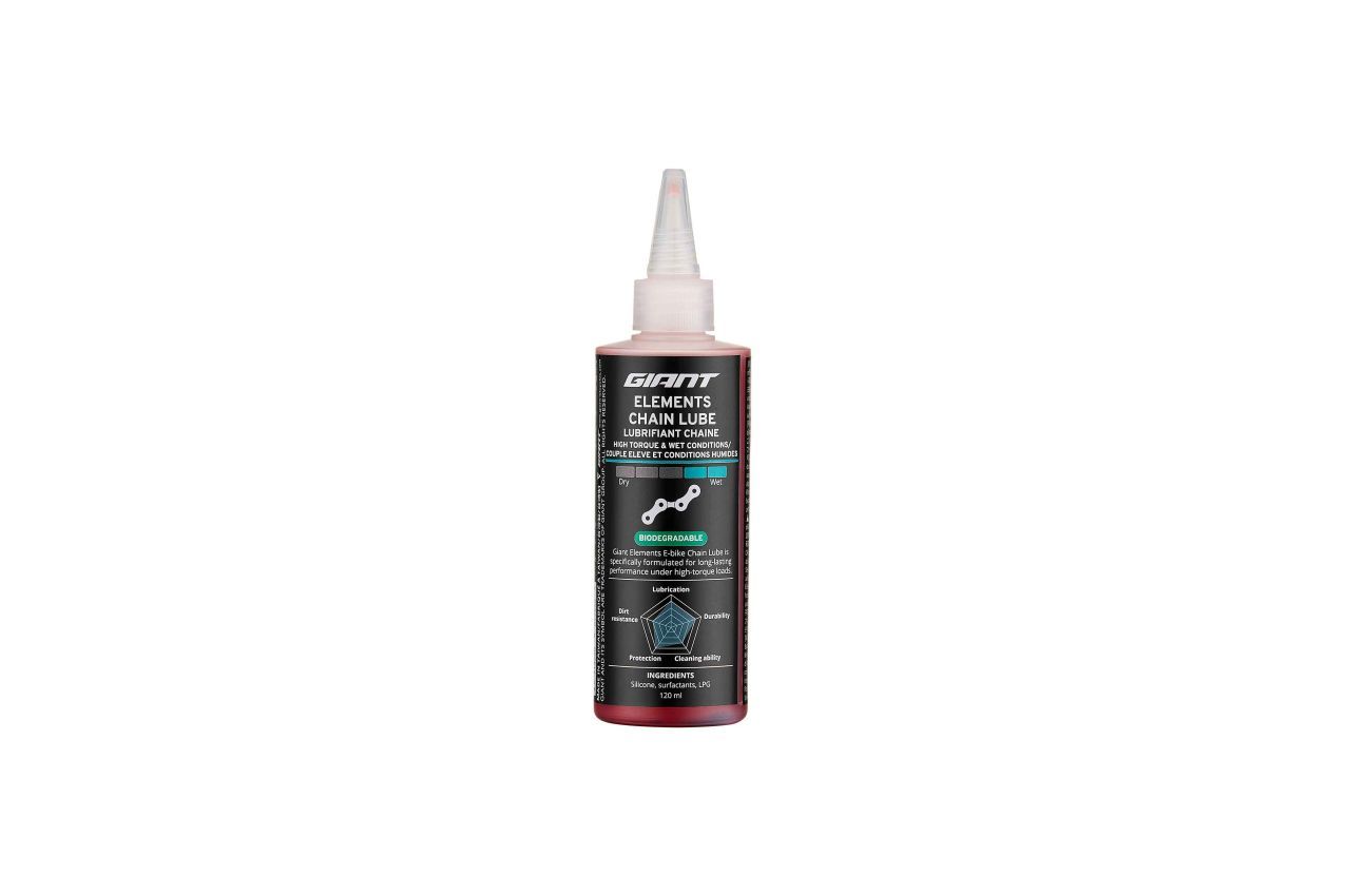 Bottle of red bicycle chain lube, with a white applicator tip.
