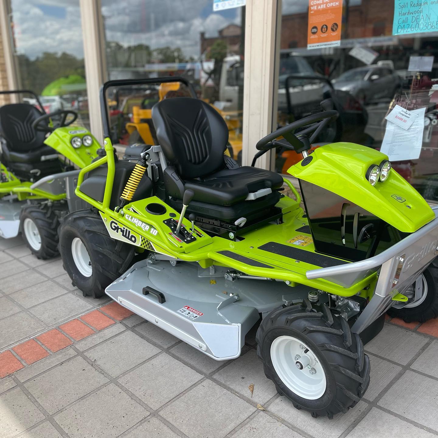 Gardener Driving A Riding Lawn Mower In A Garden — The Saw Spot In Kyogle NSW