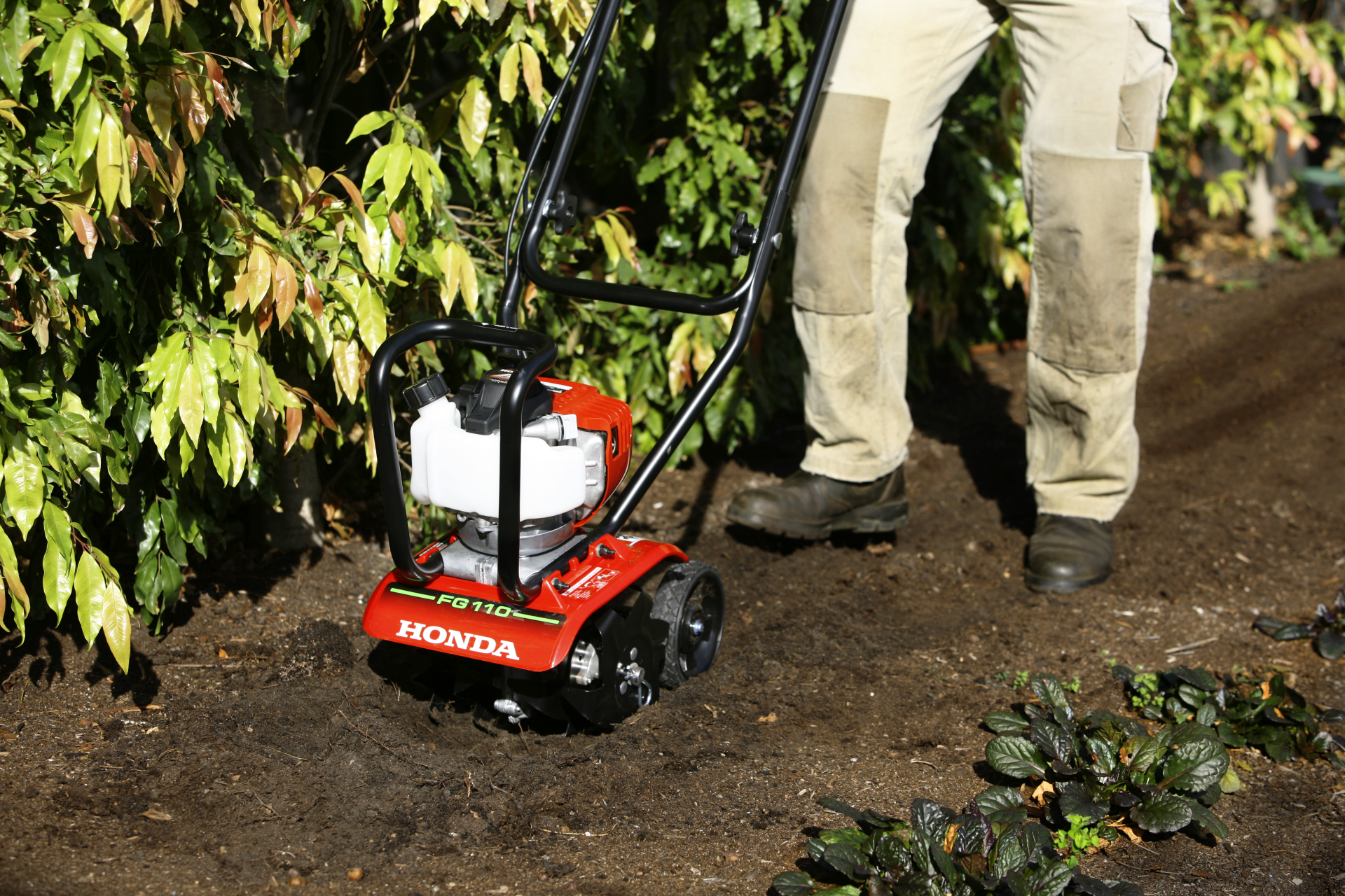 A Lawn Mower On A Lush Green Lawn Surrounded By Flowers — The Saw Spot In Kyogle NSW