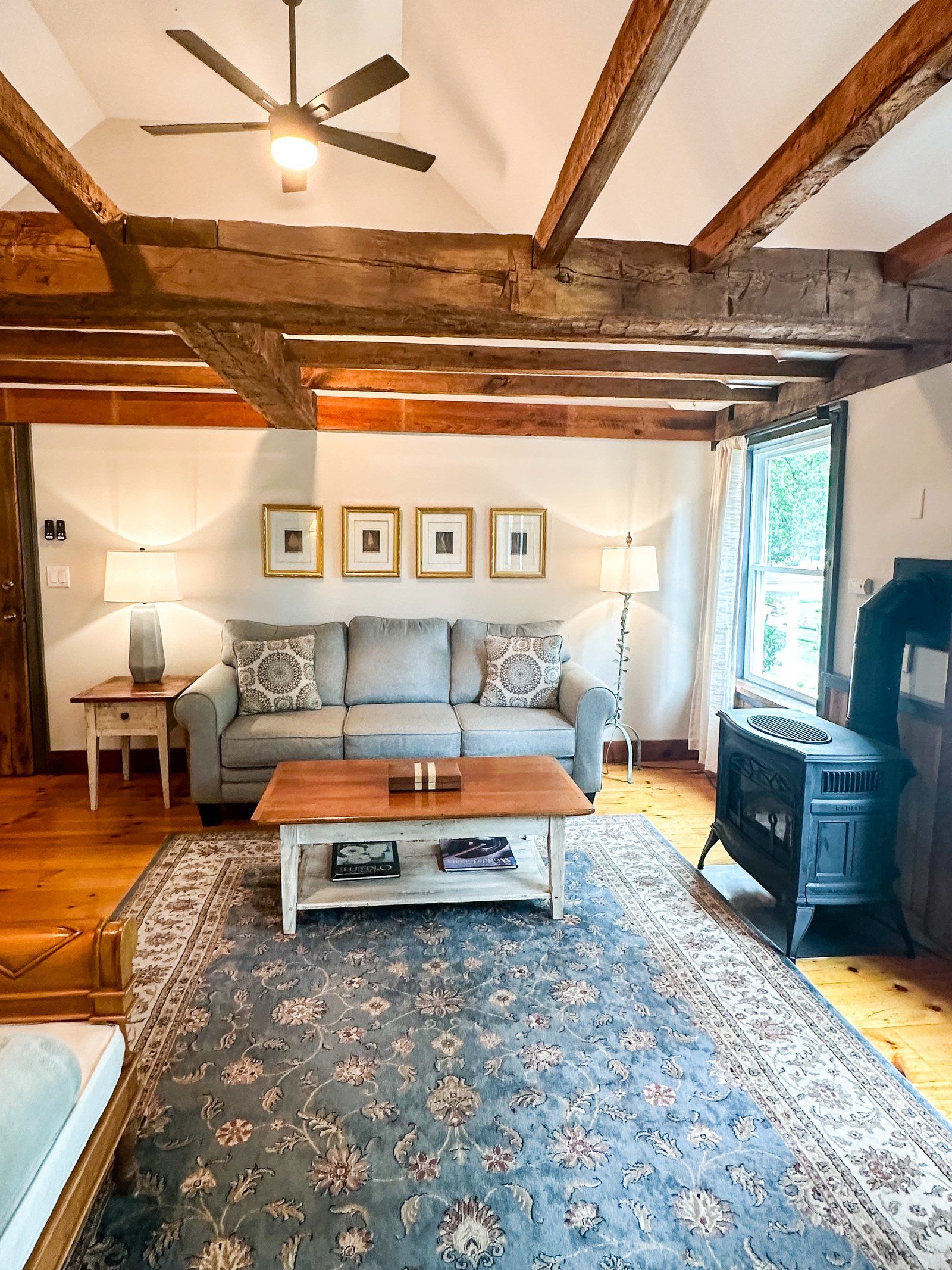 A living room with a couch , coffee table , and fireplace.