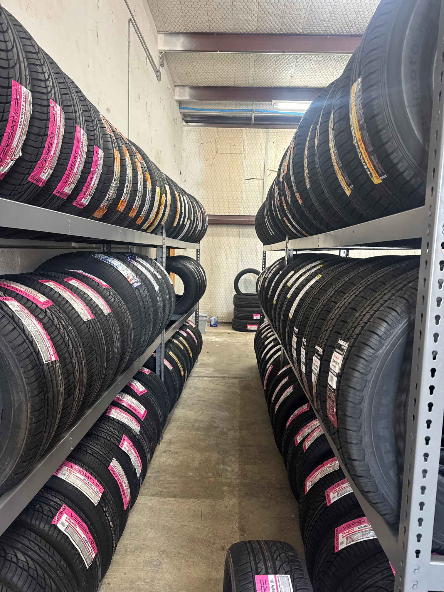 A warehouse filled with lots of tires on shelves.