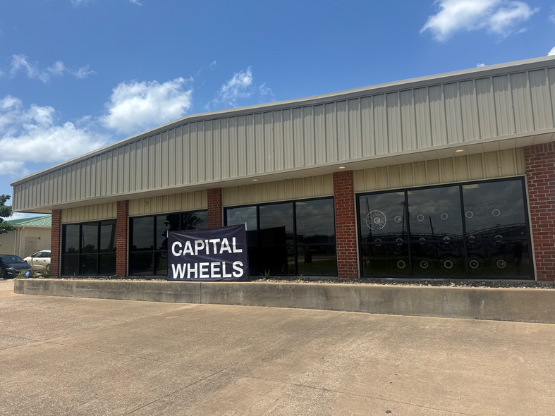 A building with a sign that says capital wheels on it.