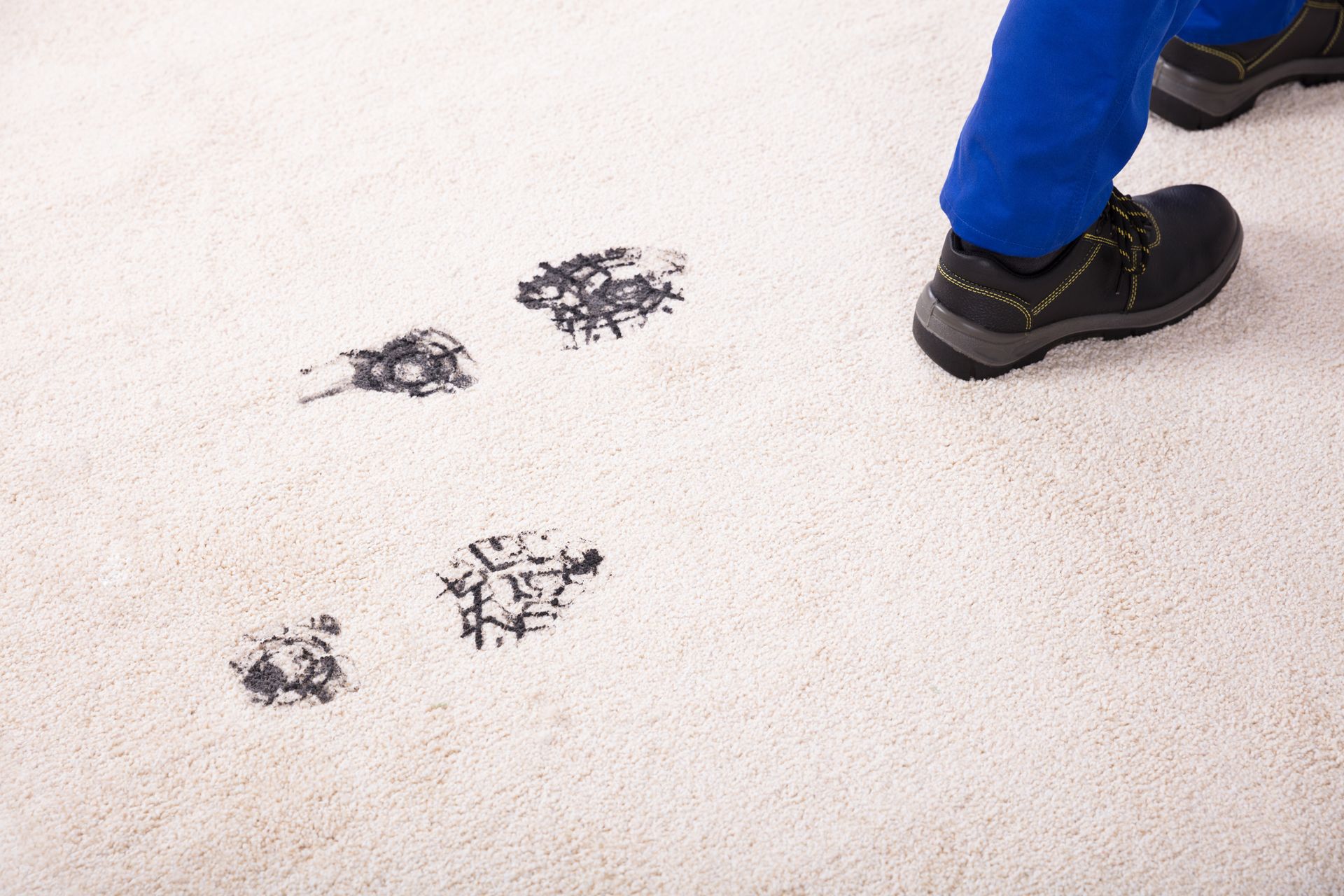 A man with dirty boots walking over and staining a clean carpet - Macomb, MI - Night Owl Express Carpet Cleaning