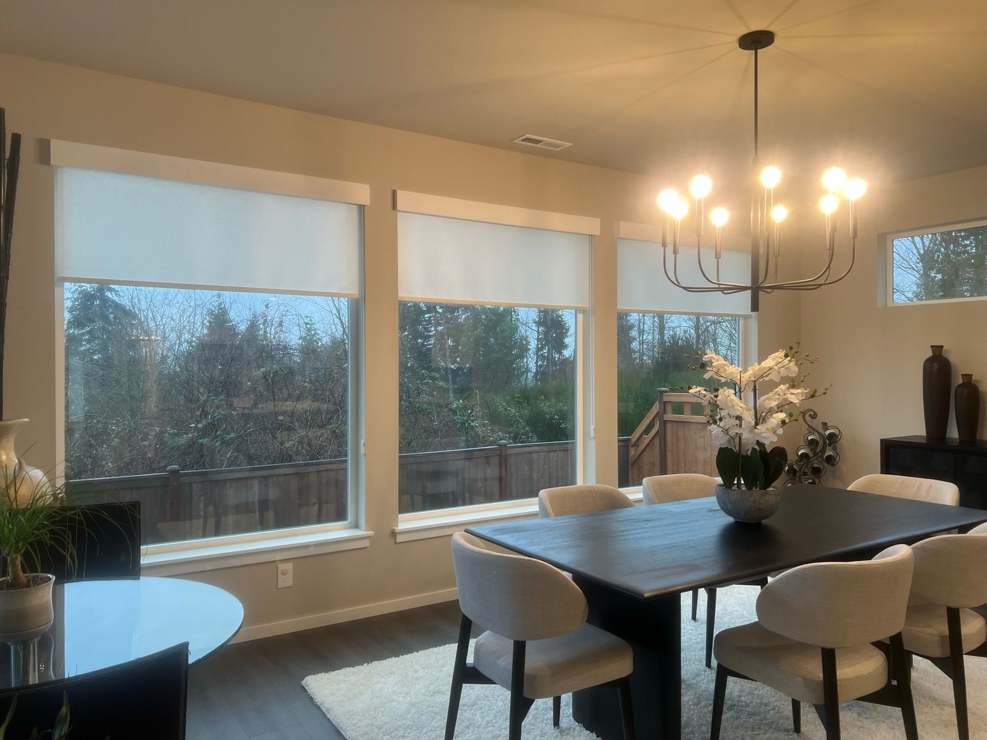 Contemporary Bellevue dining area featuring custom roller window treatments by Pugerudes