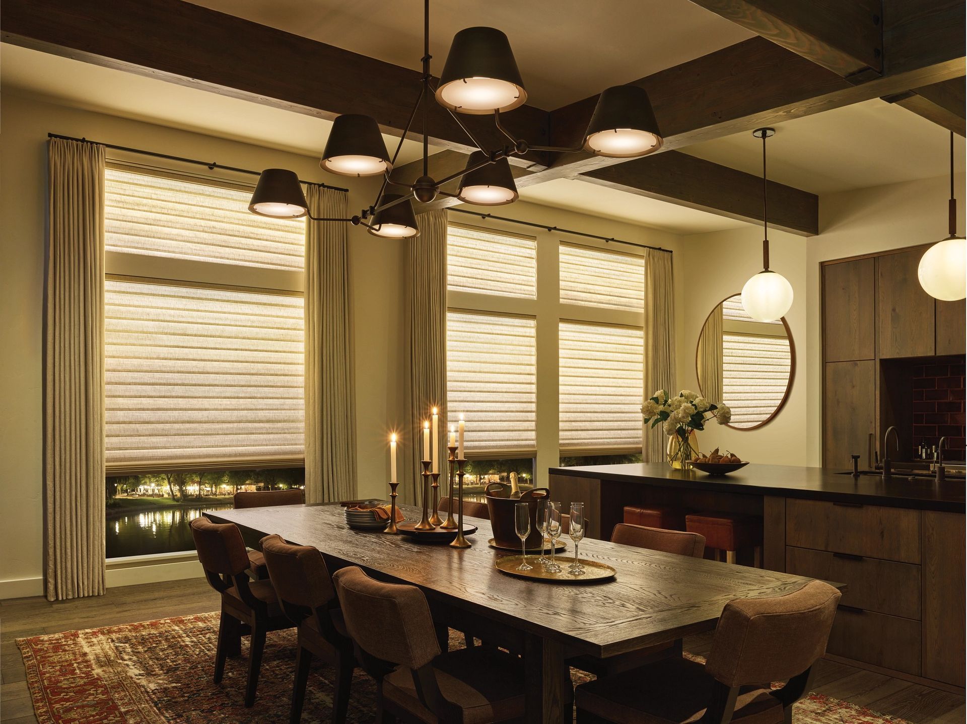 Custom window treatments with layered Roman shades in a warm Bellevue dining room for winter comfort