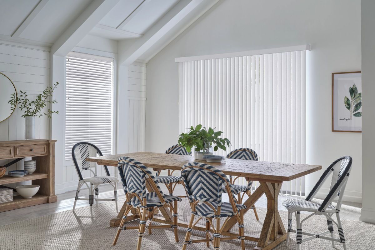 Hunter Douglas Skyline® Panel Track Blinds adorning a large window in a modern home dining room