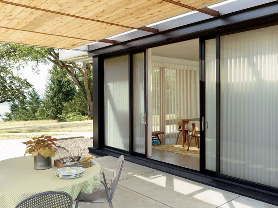 Motorized patio shades installed on a modern outdoor seating area in Kent, WA, providing sun protection and backyard comfort