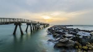 Cape Canaveral beach and lighthouse with rocket launch view — best coastal living and real estate on