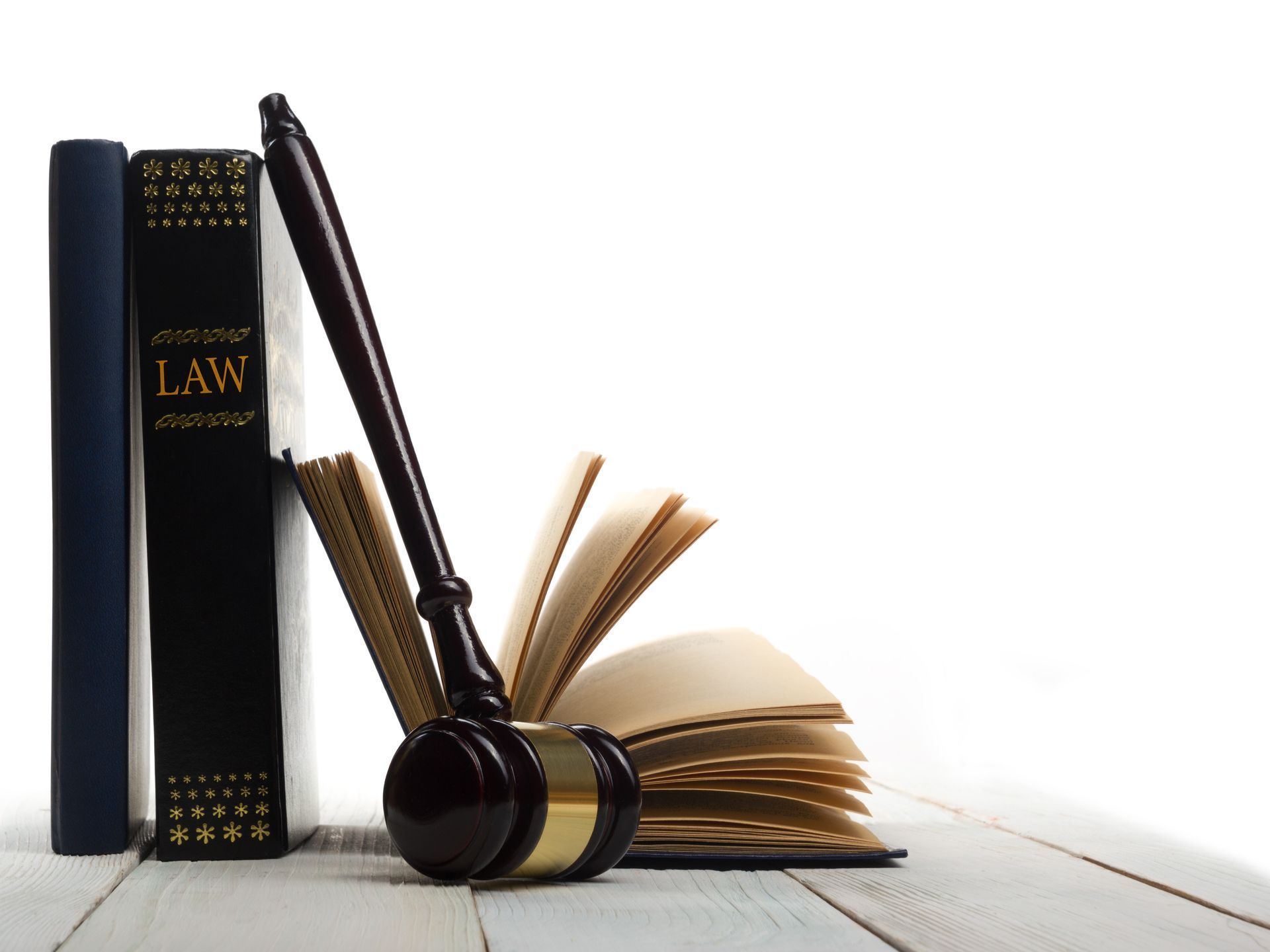 A pair of judge 's gavels sitting next to a law book