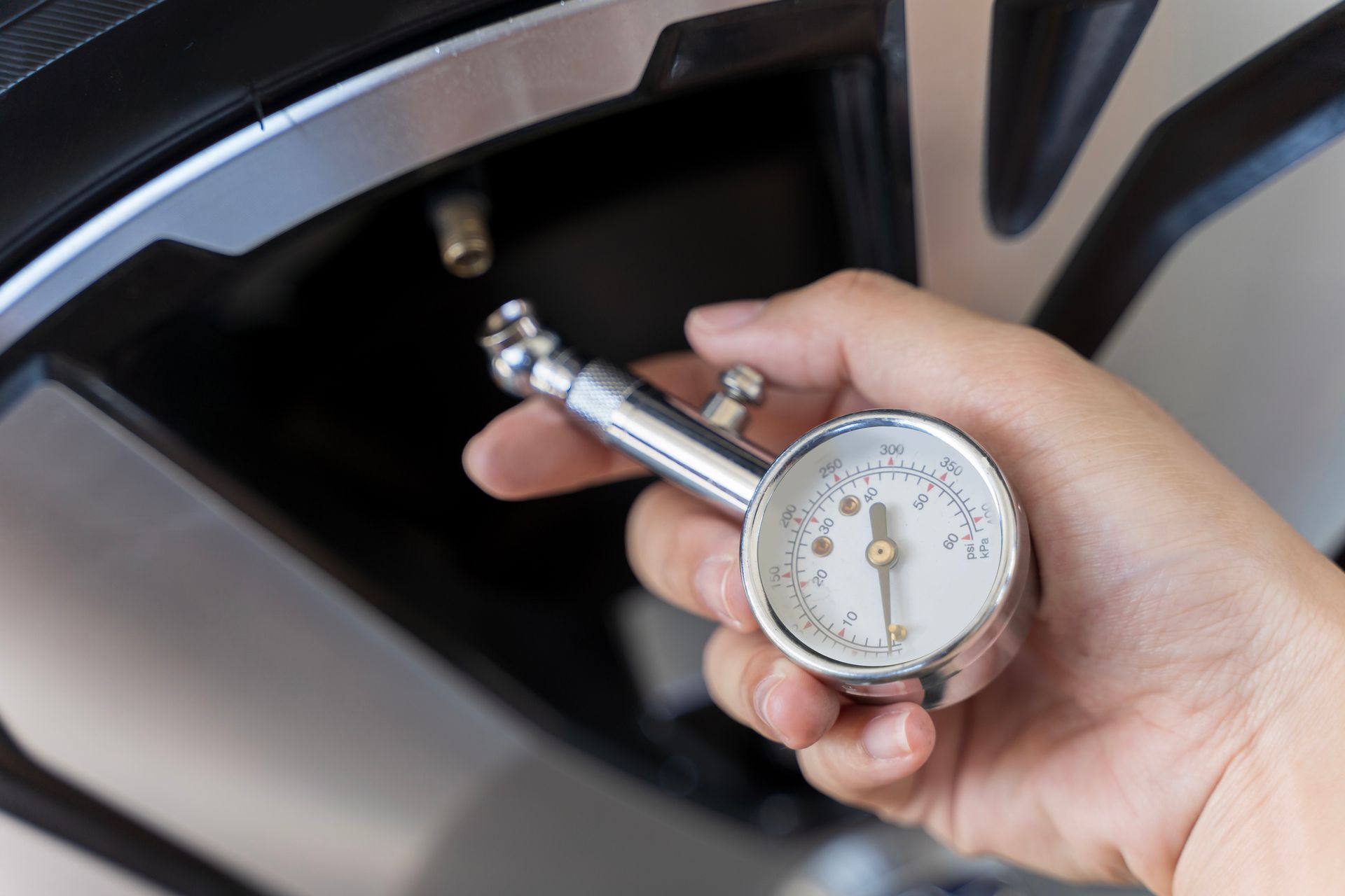 Hand man checking air pressure air car tire. Hand man checking air pressure air car tire.