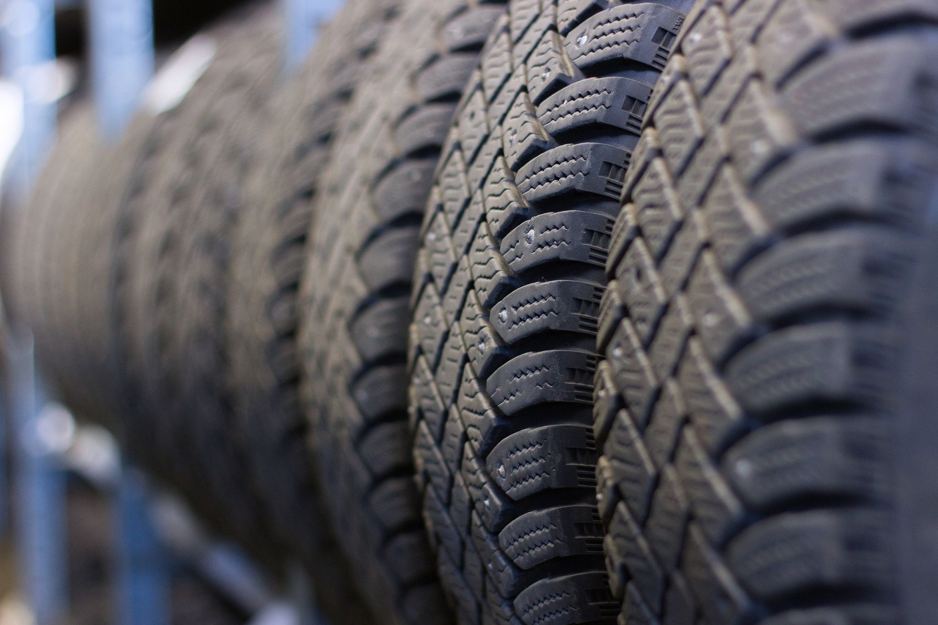 Close-up of car tire treads showing detailed grooves for traction, safety, and performance.