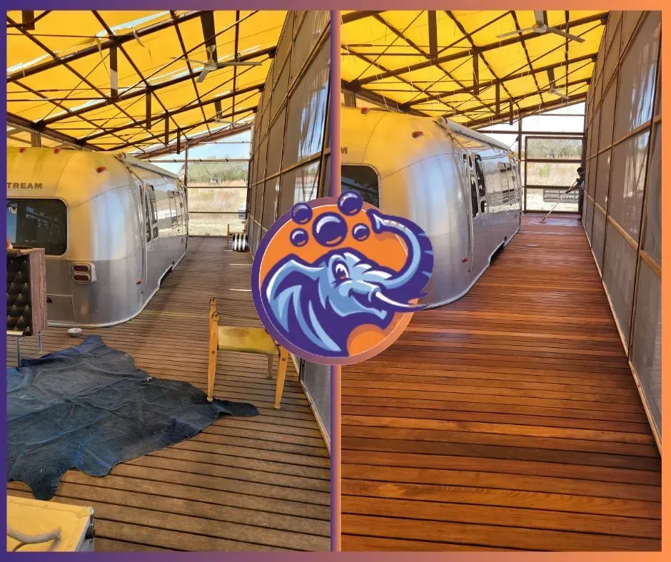 Airstreams under a yellow tarp roof. One side is faded wood, the other is freshly stained.