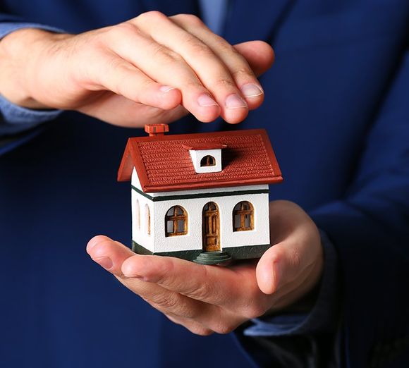 Person holding house model