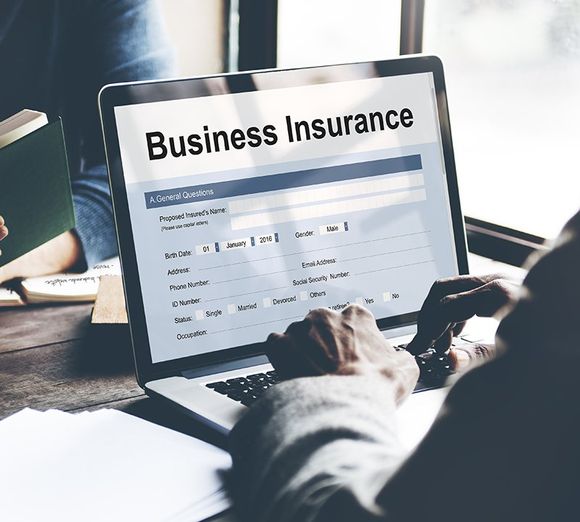 Person filling out business insurance form