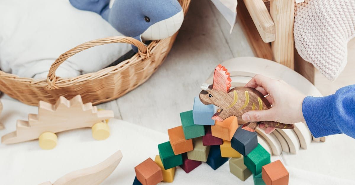 A child is playing with wooden blocks and a stuffed animal.