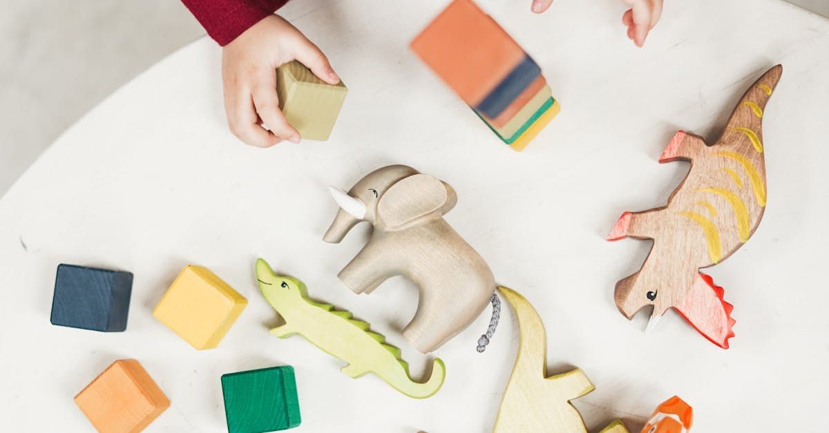 A child is playing with wooden toys on a table.