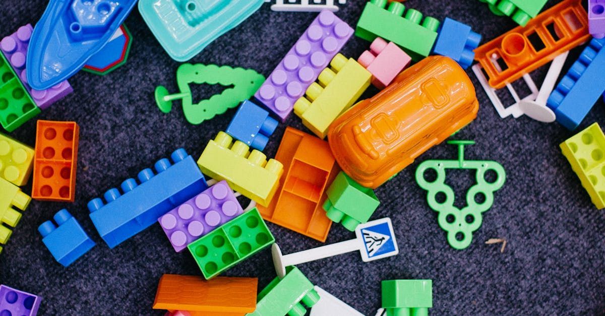 A pile of colorful plastic blocks on a carpet.