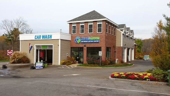 A car wash is located in the middle of a parking lot.