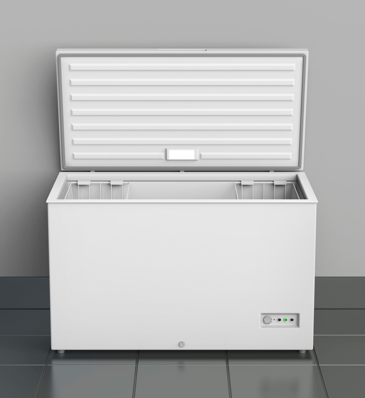 A white chest freezer with the door open is sitting on a tiled floor.