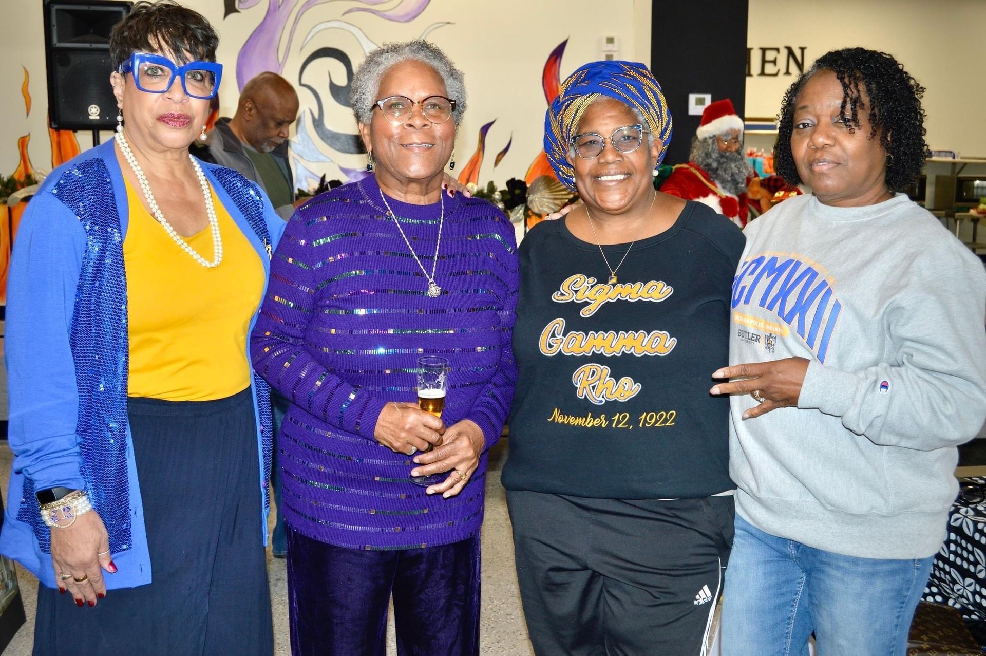 A group of women are posing for a picture in a room.