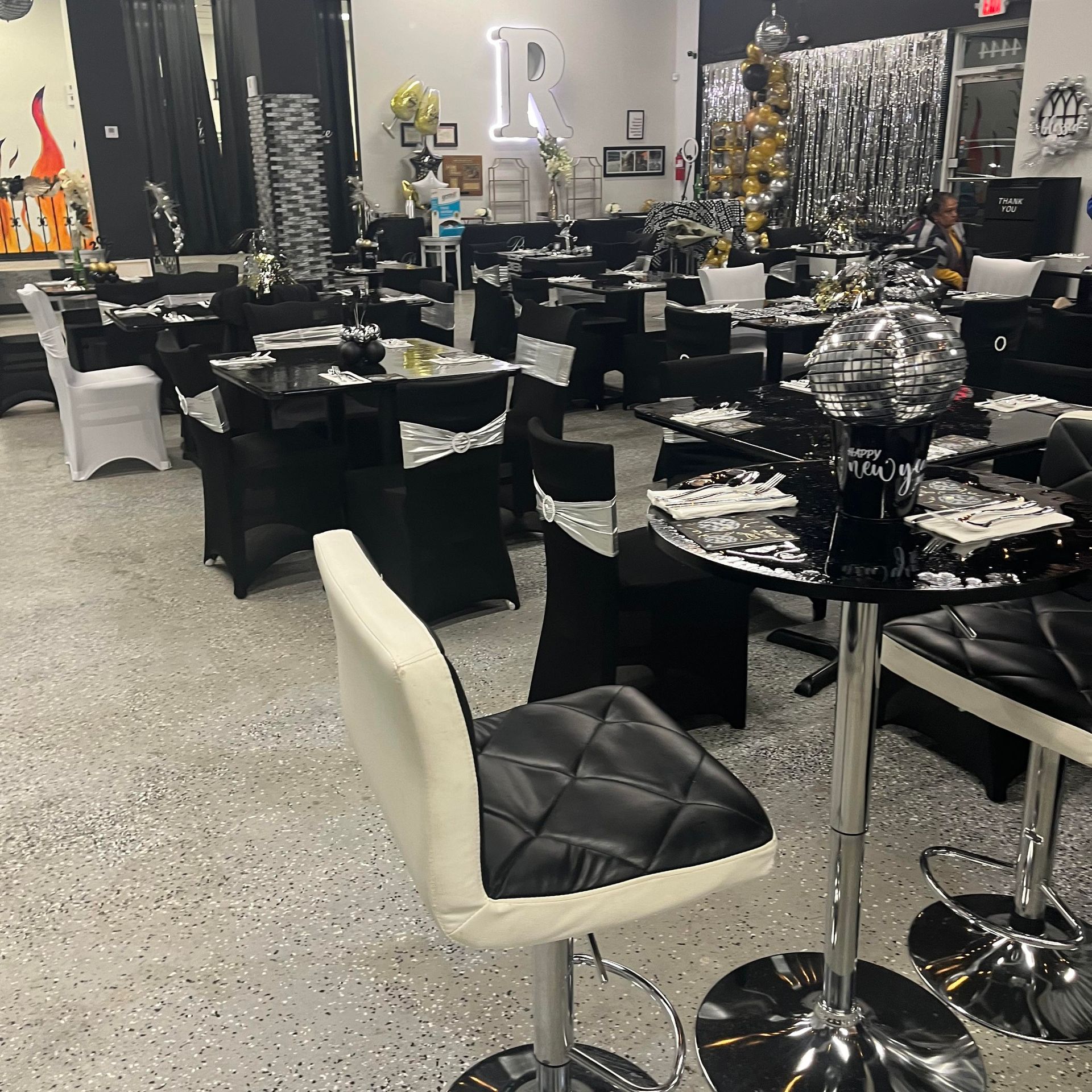 A large room with tables and chairs set up for a party