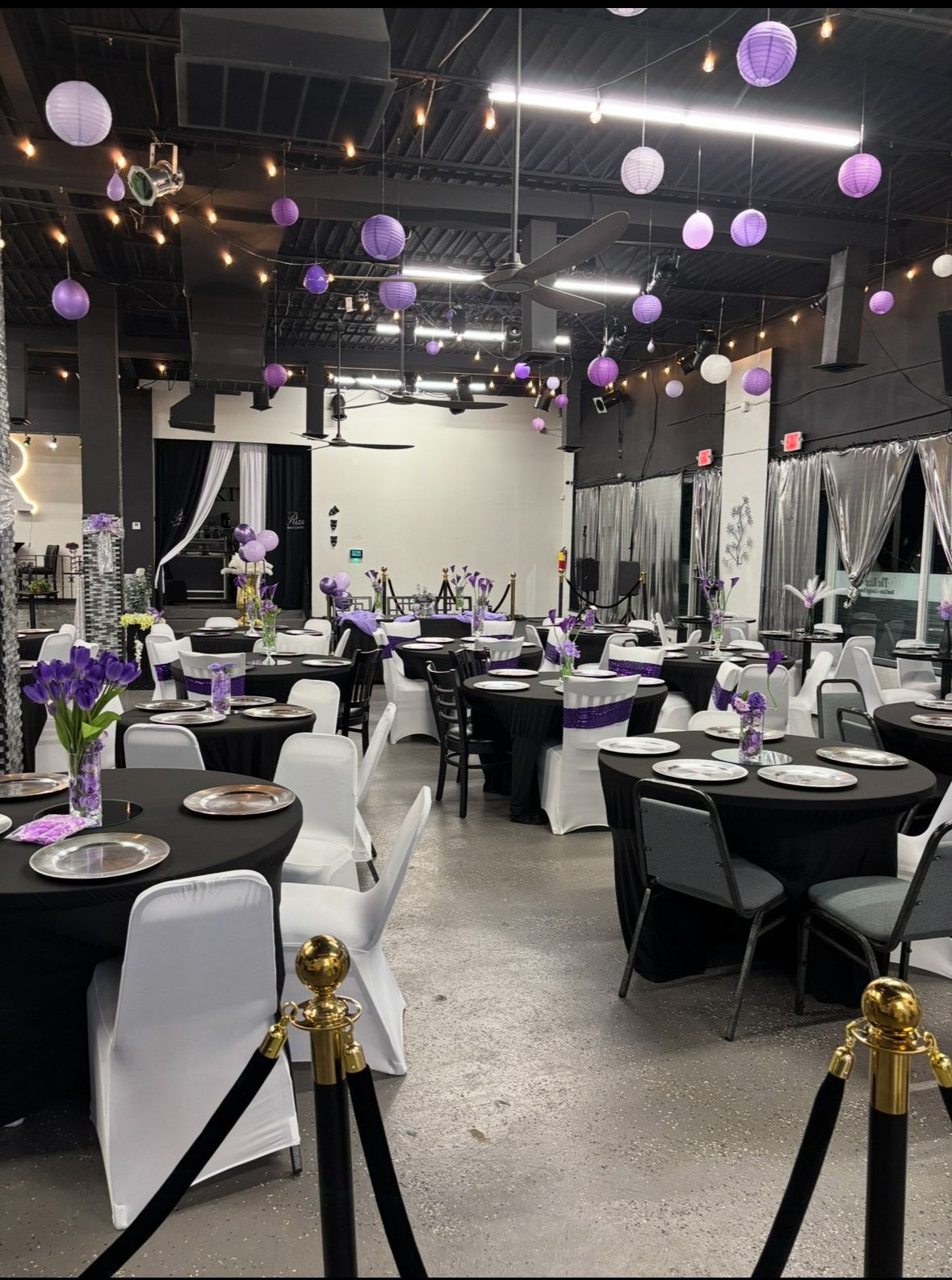 A large room with tables and chairs and a sign that says rize