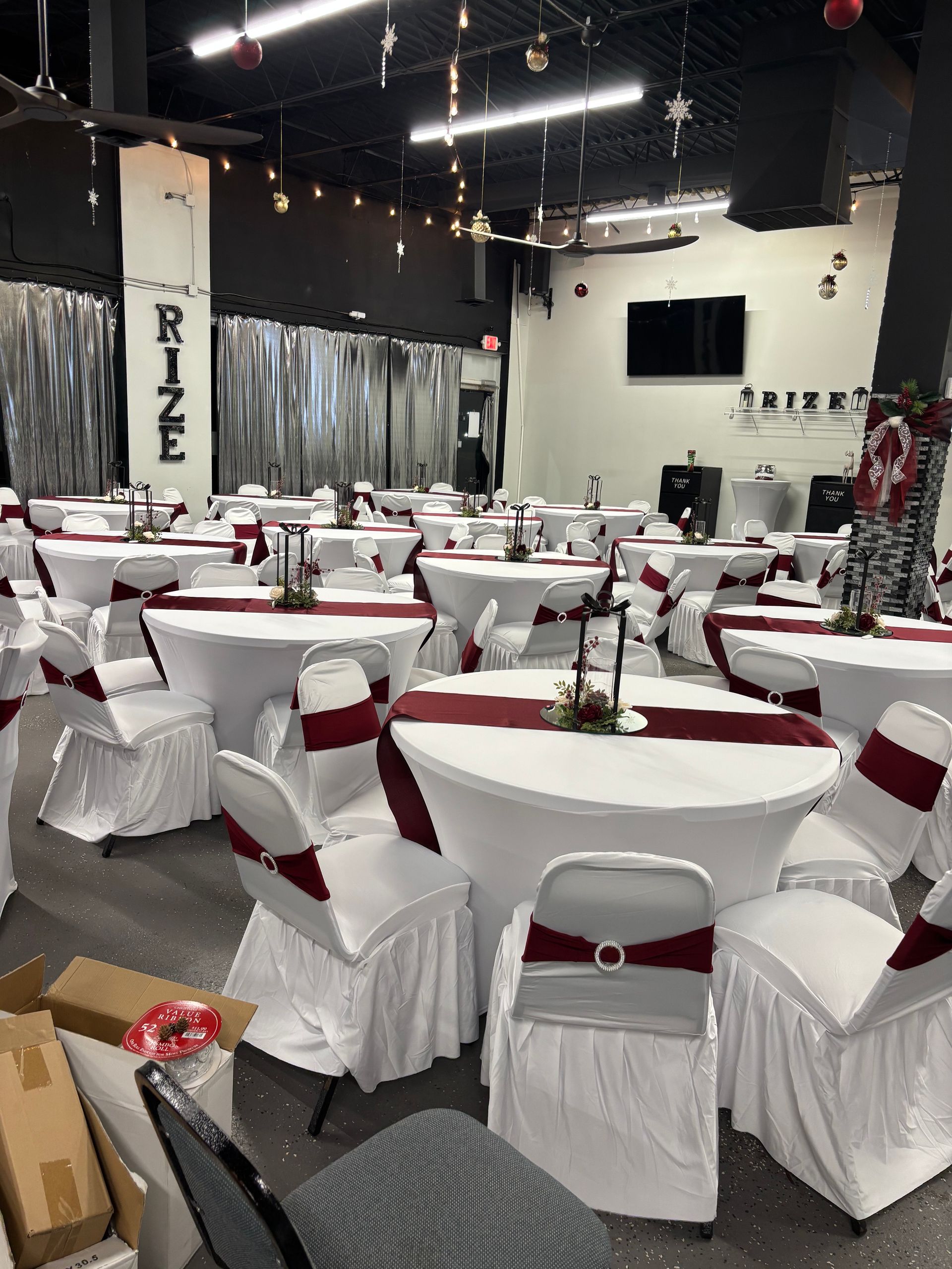 A large room with tables and chairs and a sign that says rize