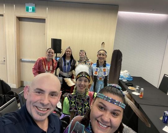 A group of people are posing for a picture in a room.