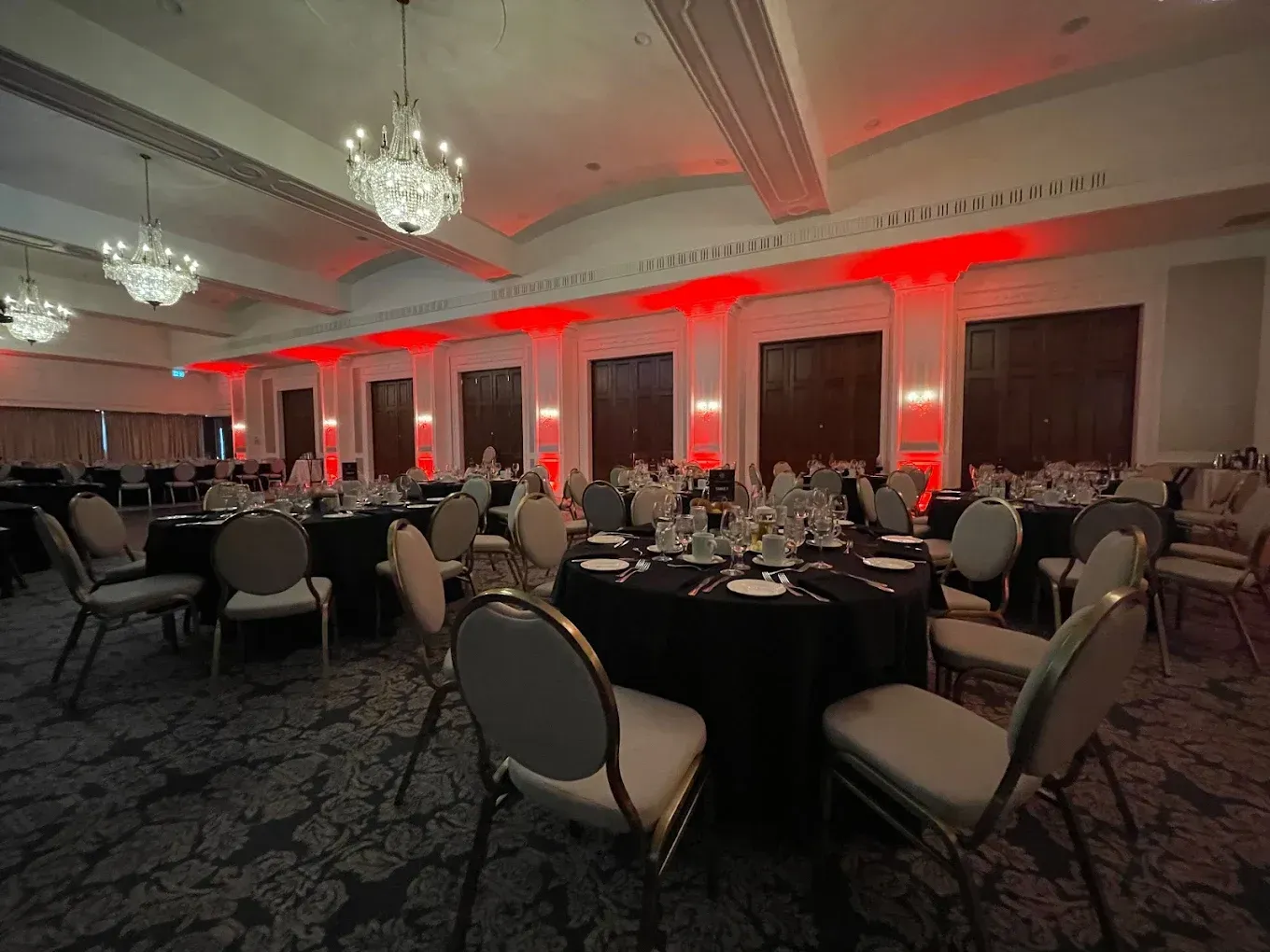 A large room with tables and chairs set up for a banquet.