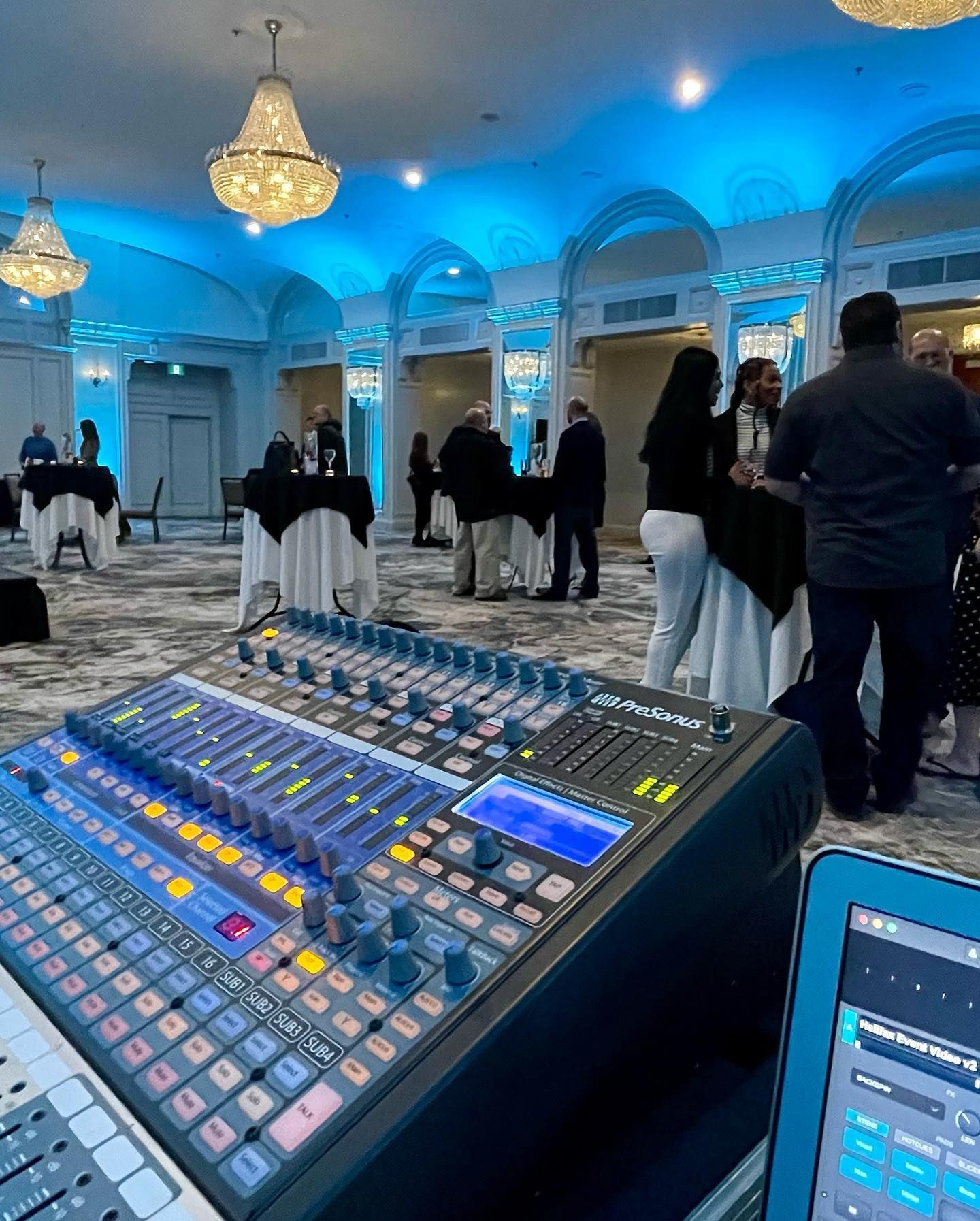 A mixer in a room with people standing around it.